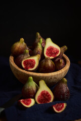 juicy fig berries in a wooden bowl