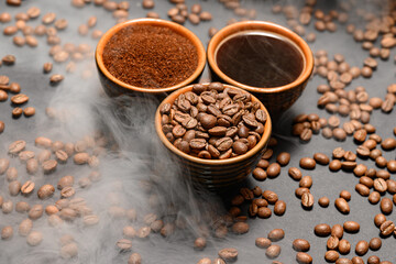Set of three cups of coffee beans, ground and drink on a black background.