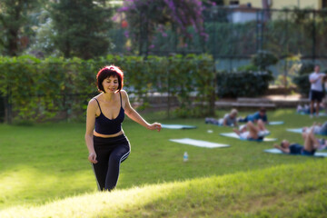Fototapeta premium Beautiful woman walking grass after yoga class.