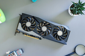 Graphics card on desk. Top view, flat lay composition. Gaming and content production hardware