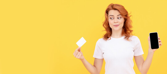 Woman isolated face portrait, banner with mock up copy space. shopping from home. cyber monday. fast pc payment. amazed girl show smartphone.