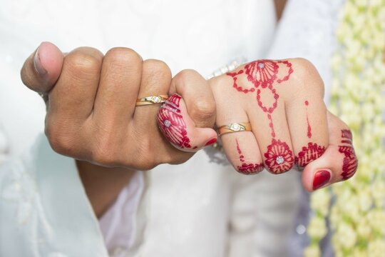 Showing Off A Ring With A Unified Concept. Young Muslim Family In Marriage Concept.