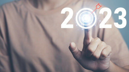 Target and goal of 2023. New year start success  plan and vision. Hand touch target arrow 2023 icon...