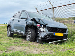 Accident car after crash stands on the side of the road with front-end damage