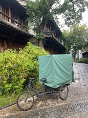 A service tricycle parked in the alleyway of a hotel in Lijiang, China - interesting vehicles used...