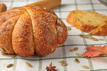 Loaf of pumpkin bread.  Homemade wholemeal rye yeast-free bread on a white striped towel
