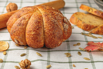 Loaf of pumpkin bread.  Homemade wholemeal rye yeast-free bread on a white striped towel
