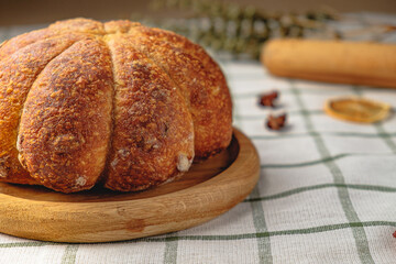 Craft pumpkin bread with pumpkin seeds . Homemade wholemeal rye yeast-free bread on a white striped towel

