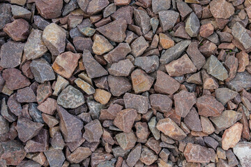 Grey and brown rubble texture. Gravel pebbles stone background. Grey and brown small rocks ground.