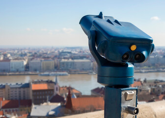 Touristic telescope look at the city  view of Budapest, close up old metal binoculars overlooking the city