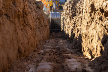 Excavator Digging a Trench for House Foundation - 544363942