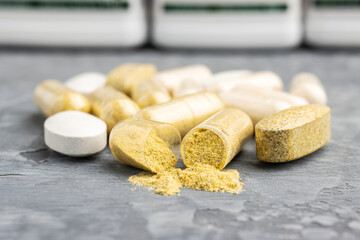 Fototapeta na wymiar Mix of herbal supplement capsules and vitamin pills