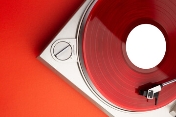 a bright red music lp record on a vinyl record player