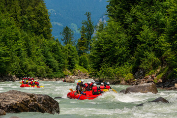 Rafting on the Lütschine near Interlaken,  Lütschine mountain river on Lake Thun in Switzerland. - obrazy, fototapety, plakaty