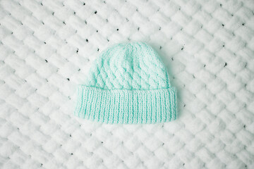 A warm hat on a white soft blanket