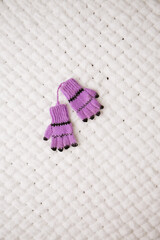 Knitted purple gloves