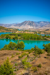 Fototapeta na wymiar Mountain Lake. Emerald water reservoir behind the dam Oymapinar. Green Canyon in Manavgat region, Turkey.