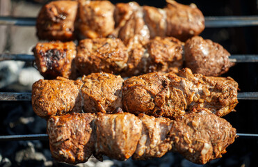 Tasty pork shashlik on the grill.