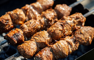 Tasty pork shashlik on the grill.