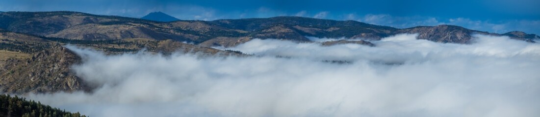 Above the clouds flowing through the mountain valley
