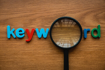 Colorful alphabet of word keyword and magnifying glass.