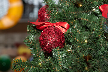 Red Christmas balls on Christmas tree. Close up