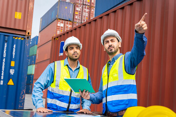 Group male engineers in a container shipping company Consulting to check the order for the container that is responsible