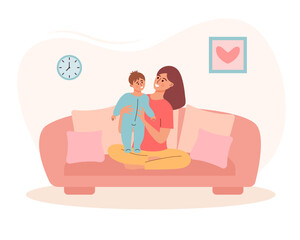 Woman with a child on the sofa. Mother holding baby boy son. Motherhood, maternity leave, baby care, spending time at home, happy family or single mother concept.