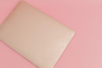 Golden laptop on a pink background