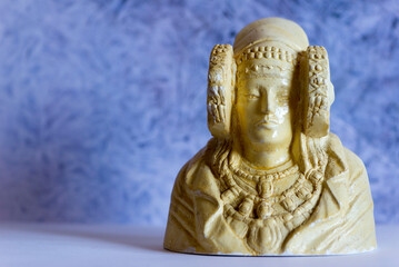 Figure of the lady of Elche with a blue background