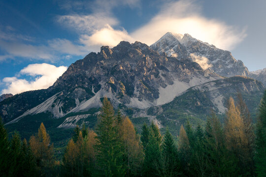 Autumnal trees in valley of picturesque mountain range