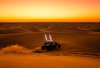 Fotobehang Offroad safari in sand desert, Empty Quarter Desert in United Arab Emirates. Offroad buggy in dunes of Rub’ al Khali desert after sunset. © Sergo