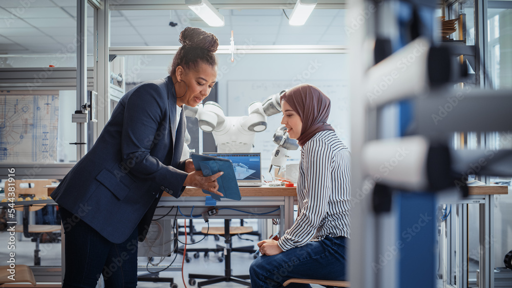 Aufkleber black senior engineer discussing robotic arm with promising arabic female computer scientist while m