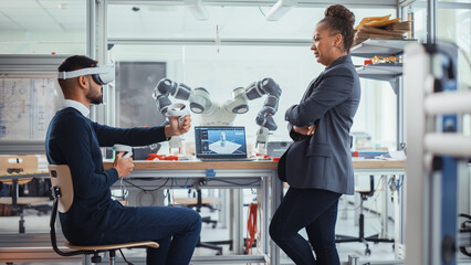 Black Chief Engineer with Laptop Giving Advices to Future Developer in VIrtual Reality Headset,...