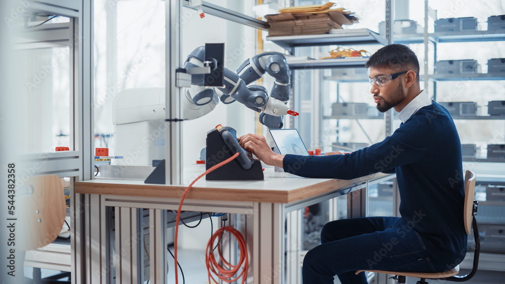Leinwandbilder Concentrated Engineer Twist Controllers and Write Code while Developing Program for Autonomous Arm at Robotics Research Center Laboratory. Optimisation and Machine Learning Concept.