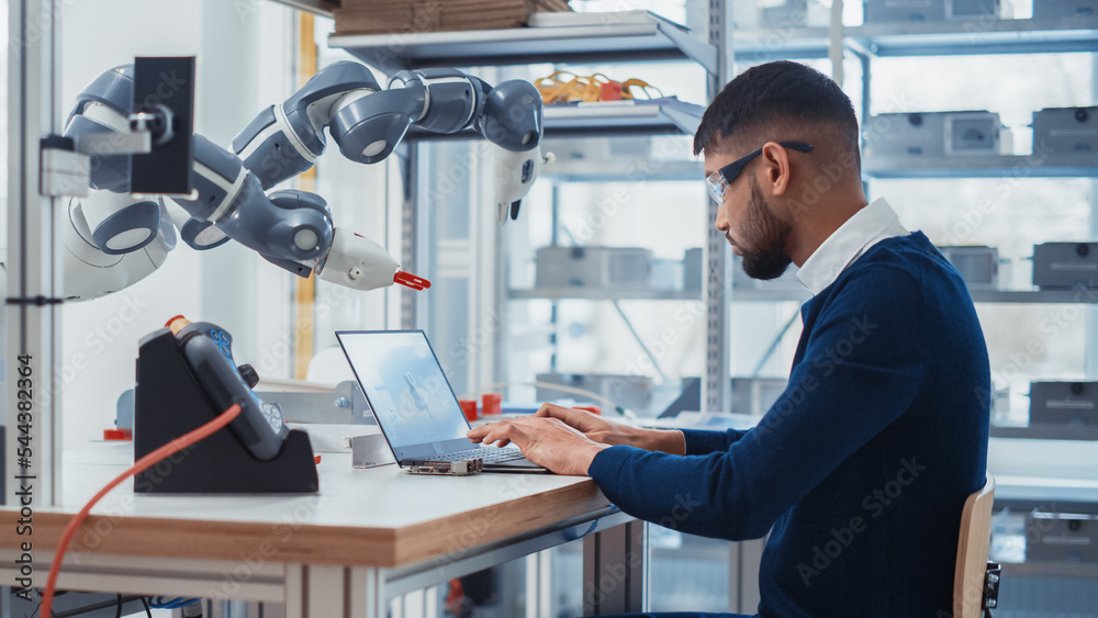 Leinwandbilder Concentrated Engineer Twist Controllers and Write Code while Developing Program for Autonomous Arm at Robotics Research Center Laboratory. Optimisation and Machine Learning in the Lab.