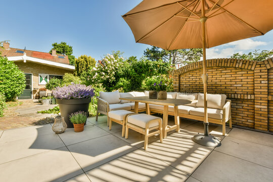 Terrace of a house with sofa and umbrella