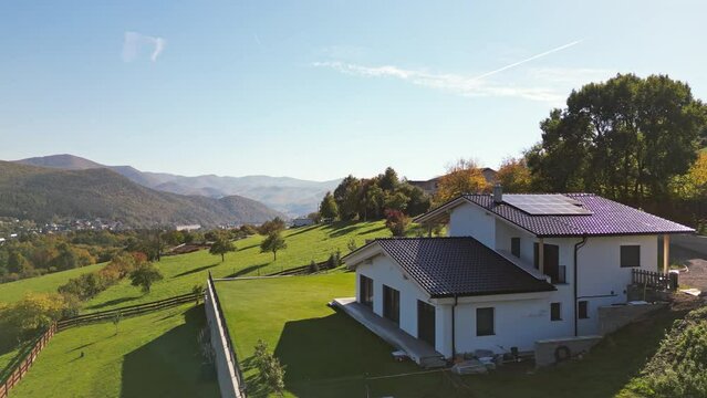 Photovoltaic panels on roof of eco house in nature.