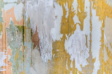 Bright yellow-green-pink-white abstract wall texture with stains of paint and plaster. Real architectural vintage pattern of the empty old scratched surface