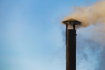 Dense smoke from the heating pipe above the house - stove heating