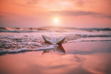 paper boat on the beach