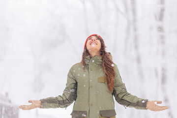 Woman enjoying snowy winter day outdoors