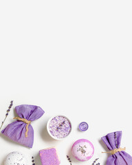 Bath bomb with natural ingredients and sea salt with lavender essential oils and scented sachets on white background. Spa products flat lay, health concept, body care treatments, top view