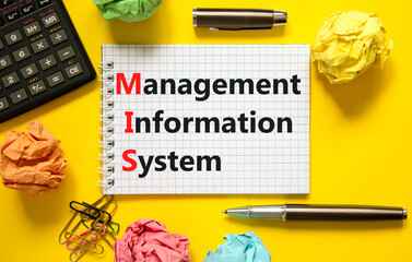 MIS management information system symbol. Concept words MIS management information system on white note on a beautiful yellow background. Business MIS management information system concept. Copy space © Dzmitry