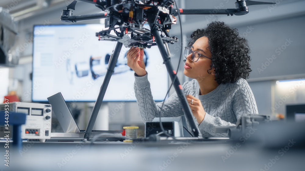 Poster concentrated black female engineer writing code. developing software for modern drone control in the