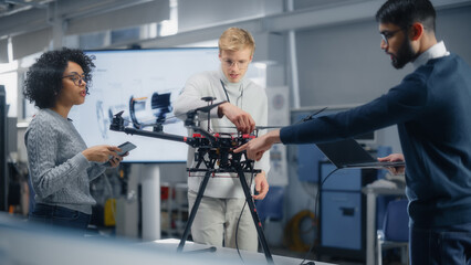 Diverse Aviation Engineers Building, Setting Up, Configuring and Testing Drones As Their Job at Modern Factory. Aviation Industry and Innovative Technological Startup Concept.