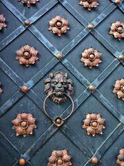 Old door with flowers and lion door handle, antique door knocker