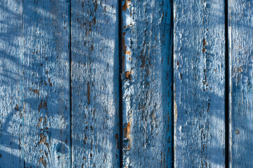 Fototapeta na wymiar old wooden background of painted boards with cracked and peeling paint
