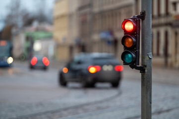 traffic light on the street junction with beautiful bokeh, city with cars in the background