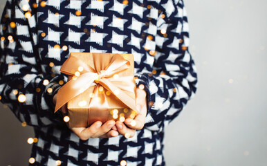 A girl holds a gift in her hands